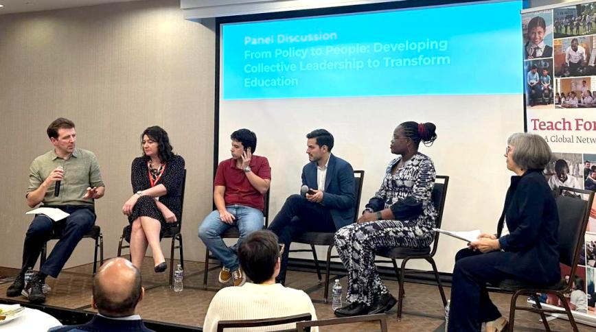 SIx people in chairs in front of a screen. 